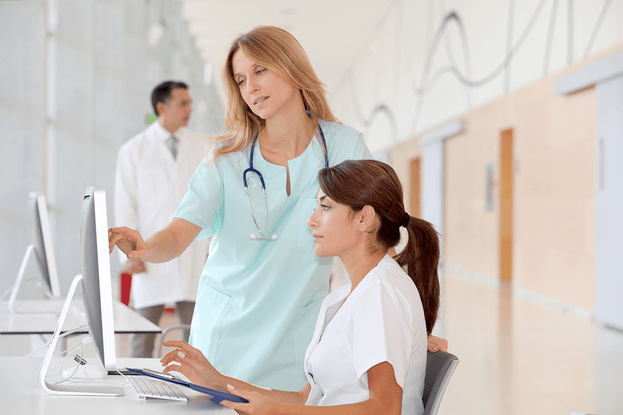 Teacher explaining techniques to a nursing student.