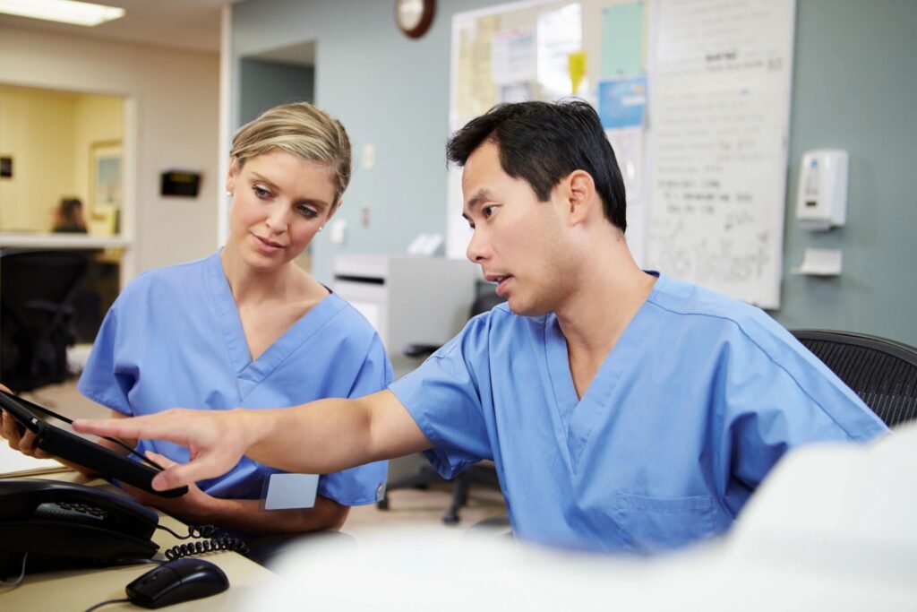 Two nurses working at a hospital.